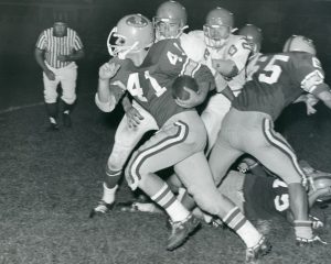Player running football at The Bishop Kenrick Highschool